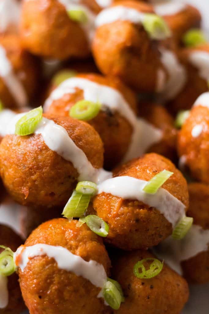 Chicken buffalo meat balls with ranch and onions on top