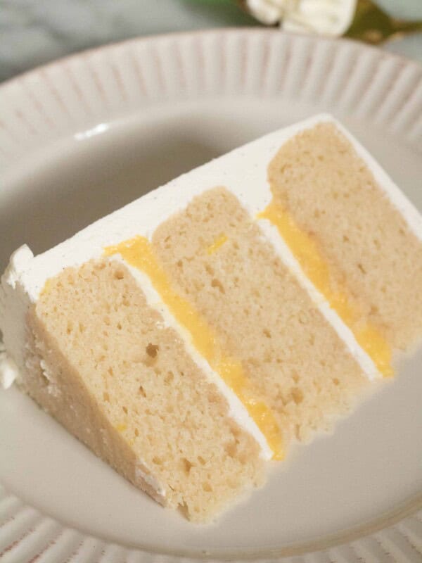 layered vanilla cake with lemon curd and vanilla bean italian meringue buttercream