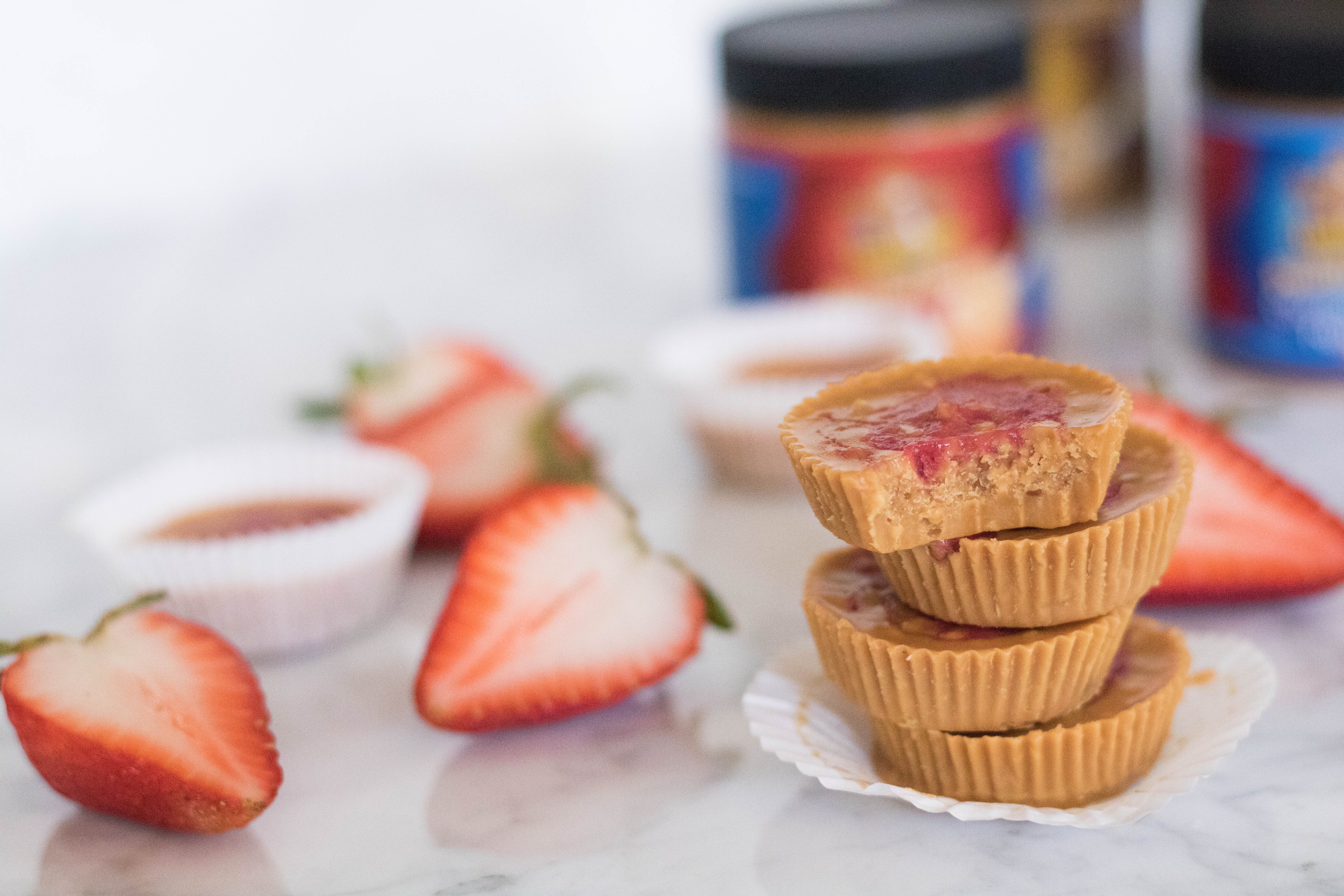 Healthier peanut butter and jelly swirl cups as a snack stacked on top of each other
