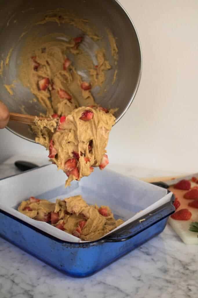 Thick strawberry blondie batter poured into pan 