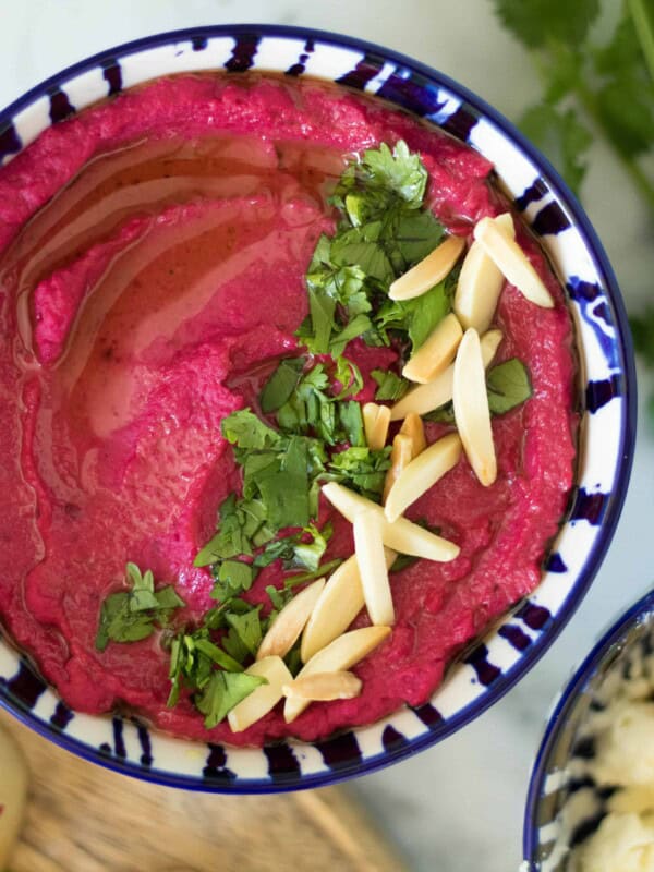 Fresh beetroot hummus with almonds and parsley on top
