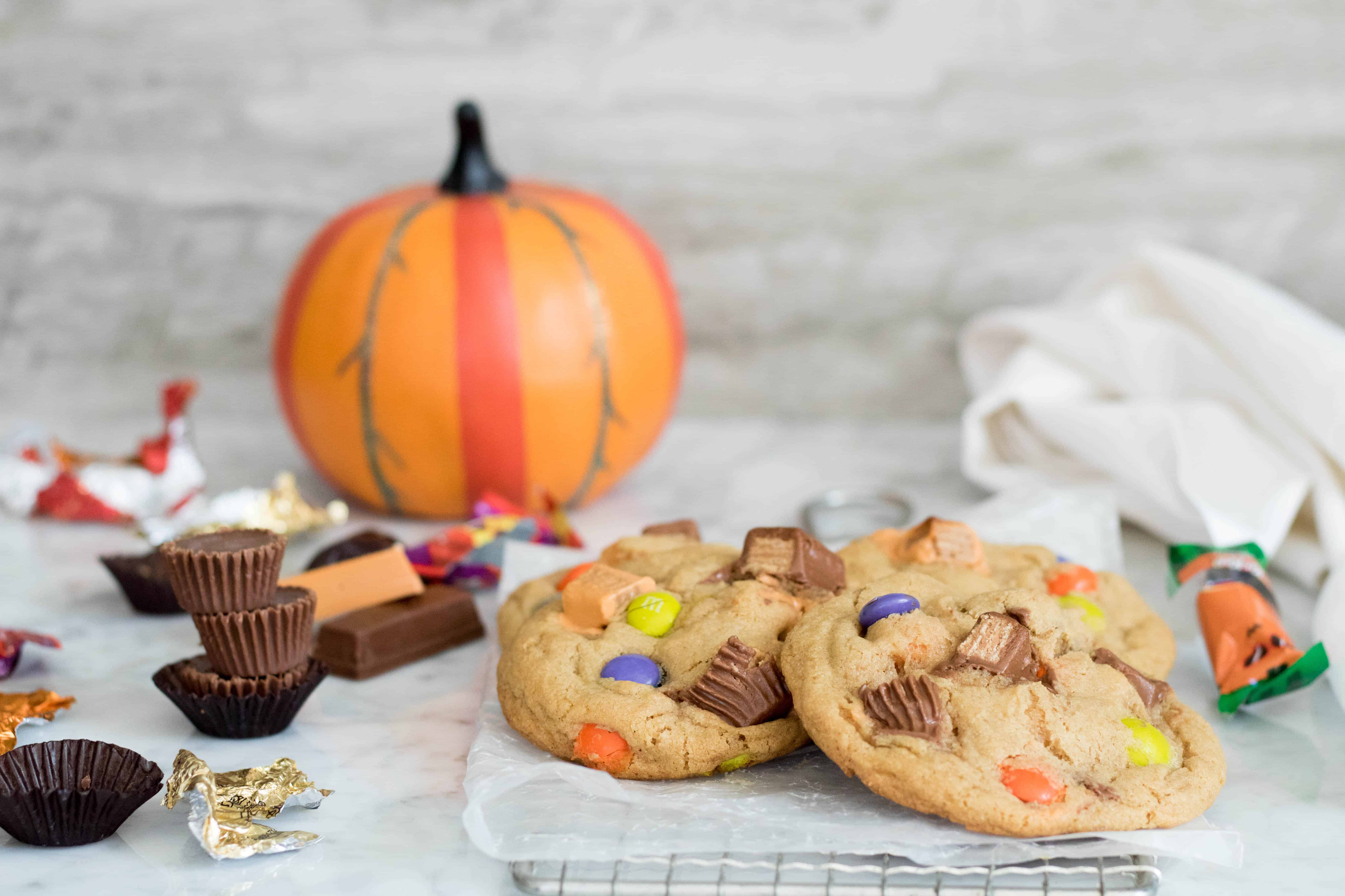 2 large halloween cookies with lots of different leftover chocolate and candies