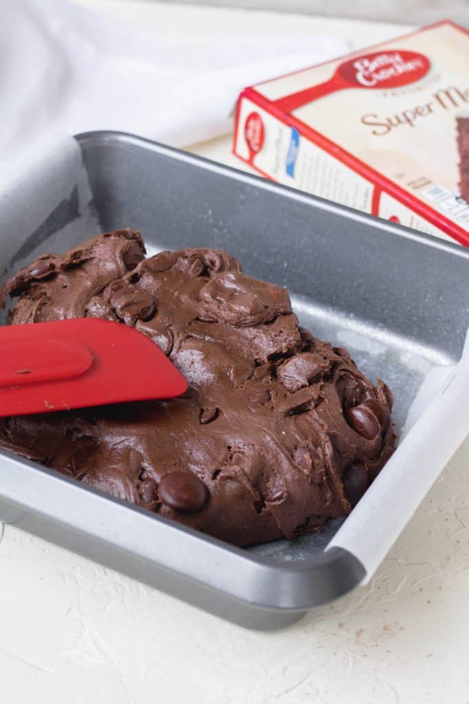 Spreading the brownie batter into the baking dish