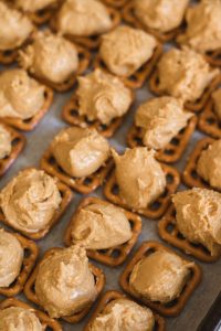 Peanut butter balls on pretzels for buckeye bites