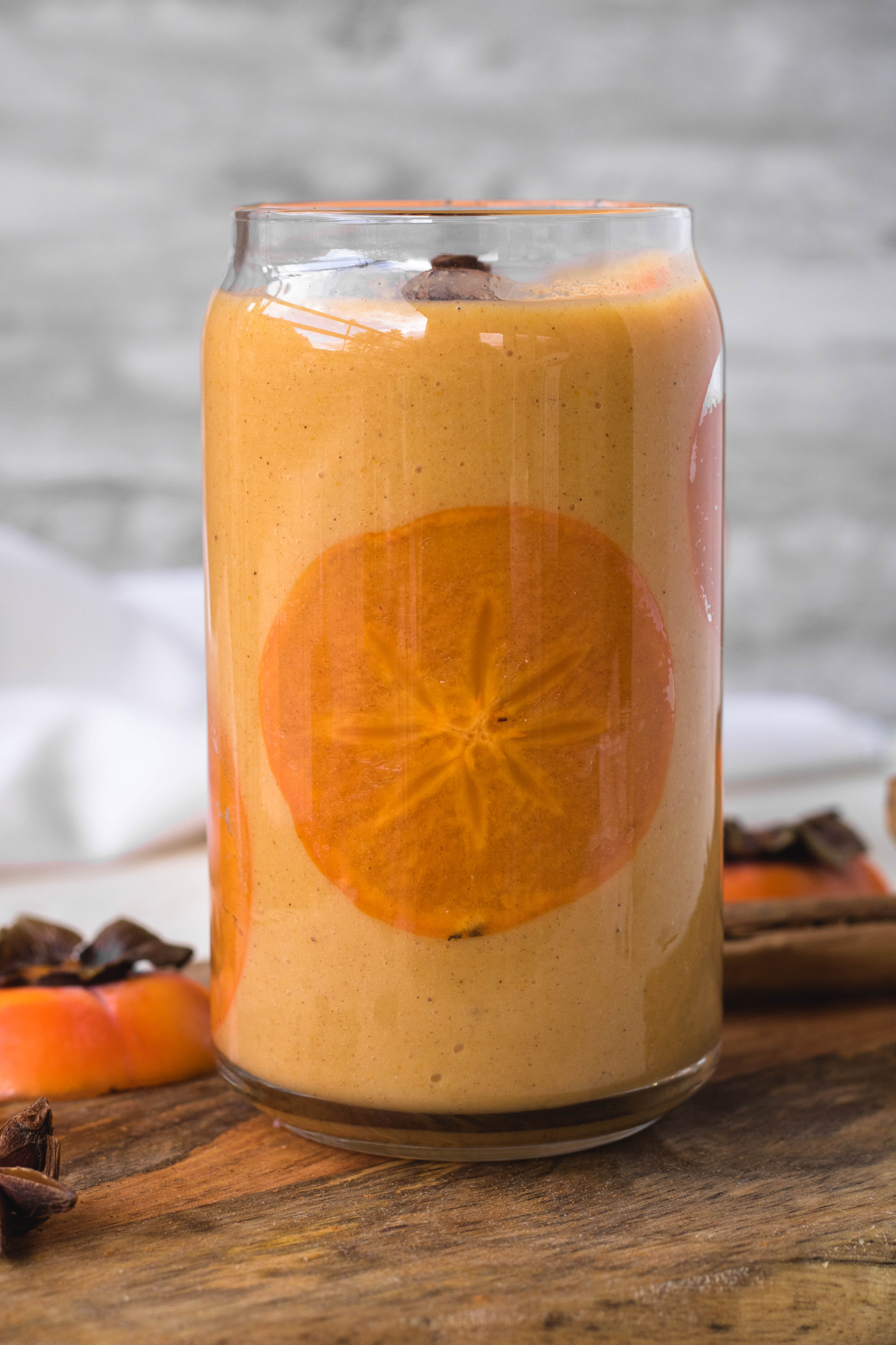 easy persimmon smoothie with a thin slice of persimmon inside