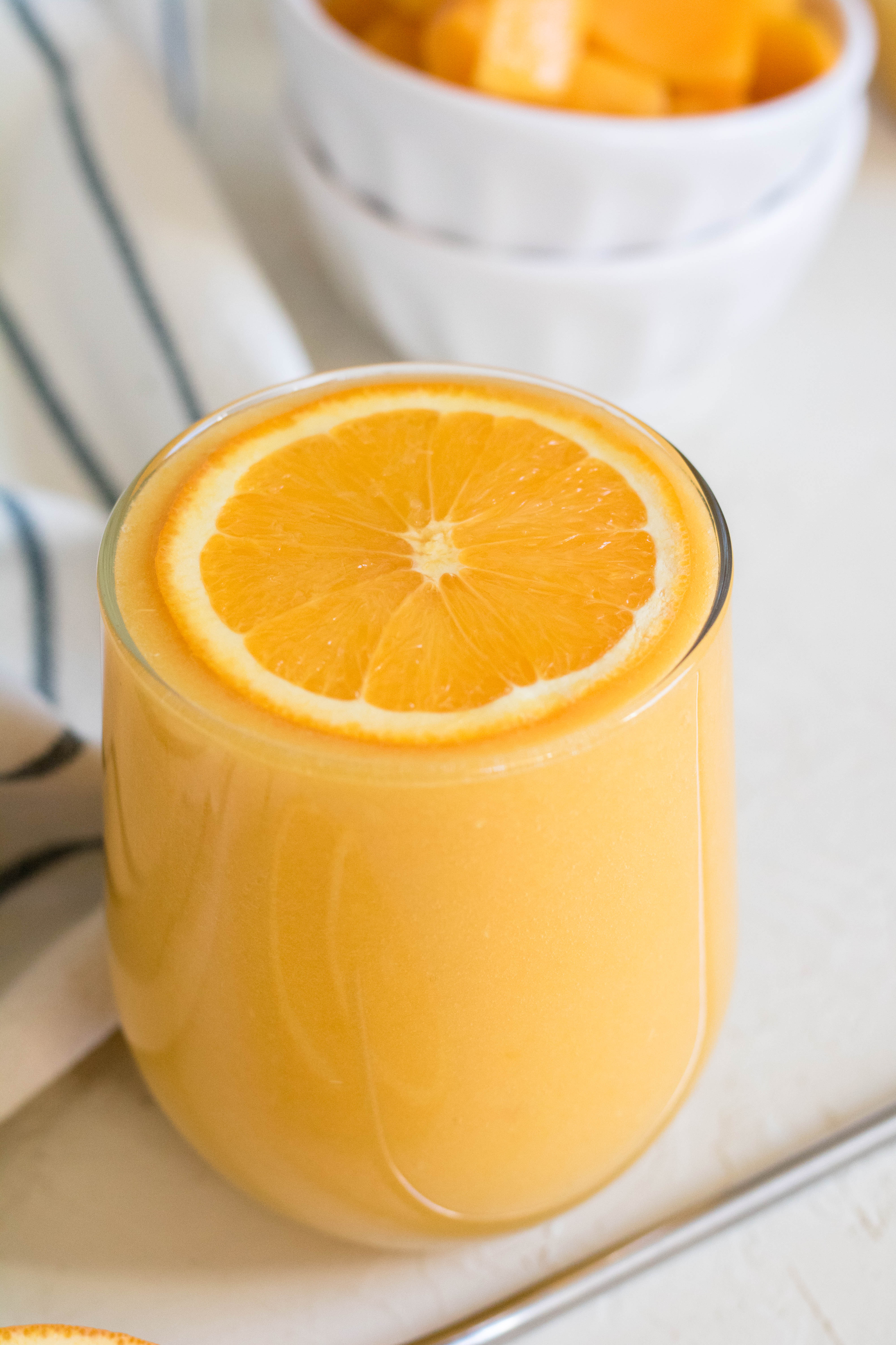 mango orange smoothie with orange slice on top