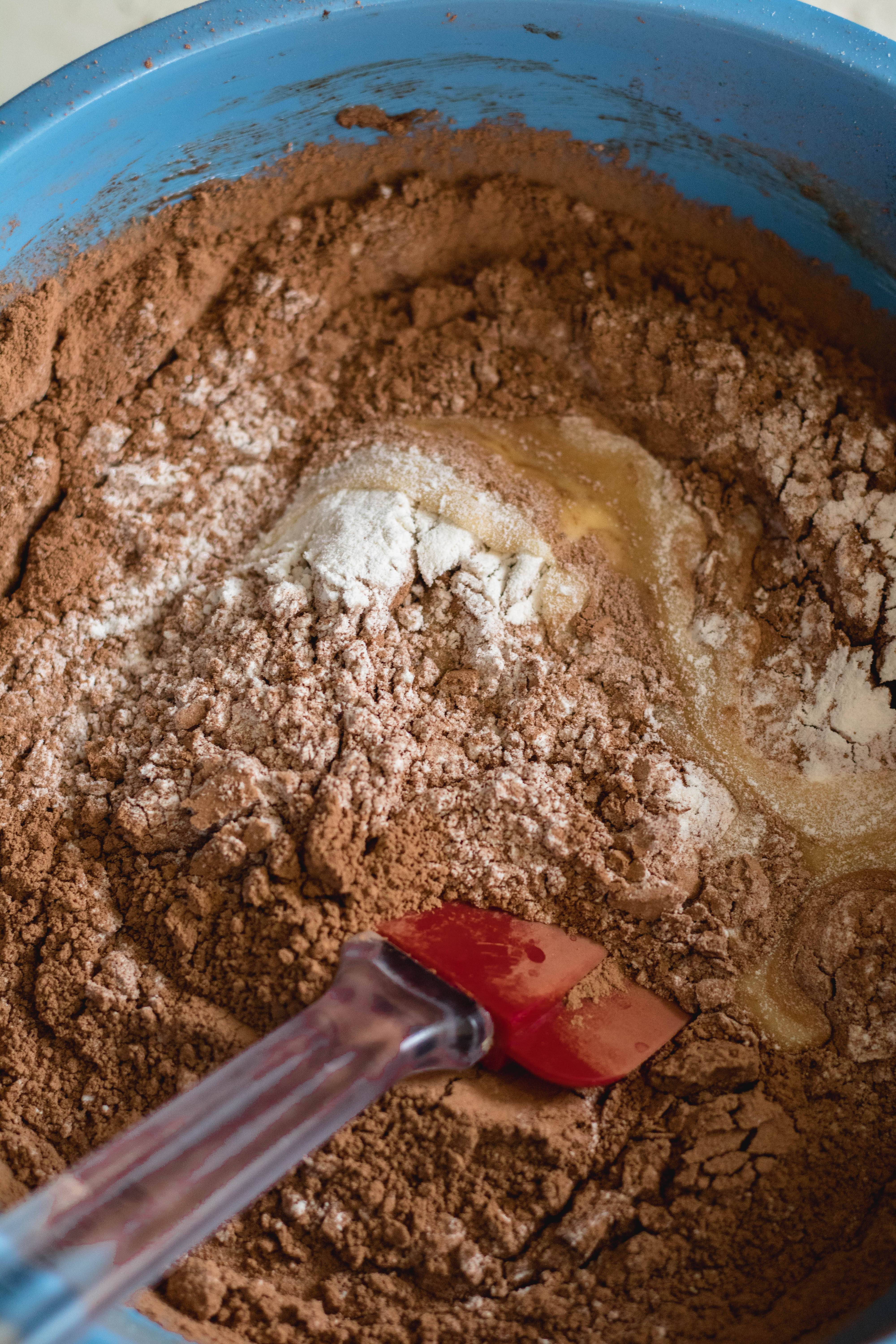 adding the dry ingredients to the brownie mix