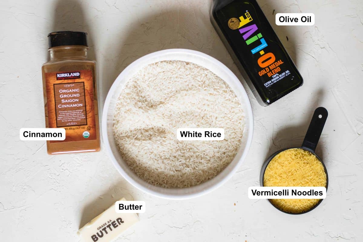 Ingredients for Lebanese rice pilaf, including white rice, vermicelli noodles, butter, cinnamon, and oil.