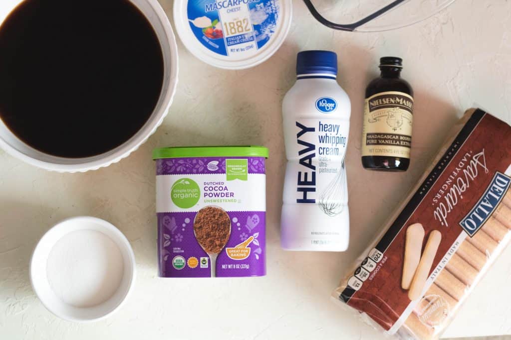 Ingredients for easy tiramisu including mascarpone, cream, coffee, cocoa powder, and ladyfingers