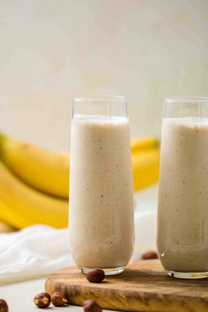 banana hazelnut smoothie with cacao nibs on top 