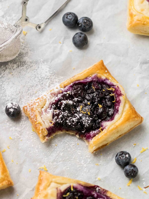 blueberry cheese danish with a bite on the edge
