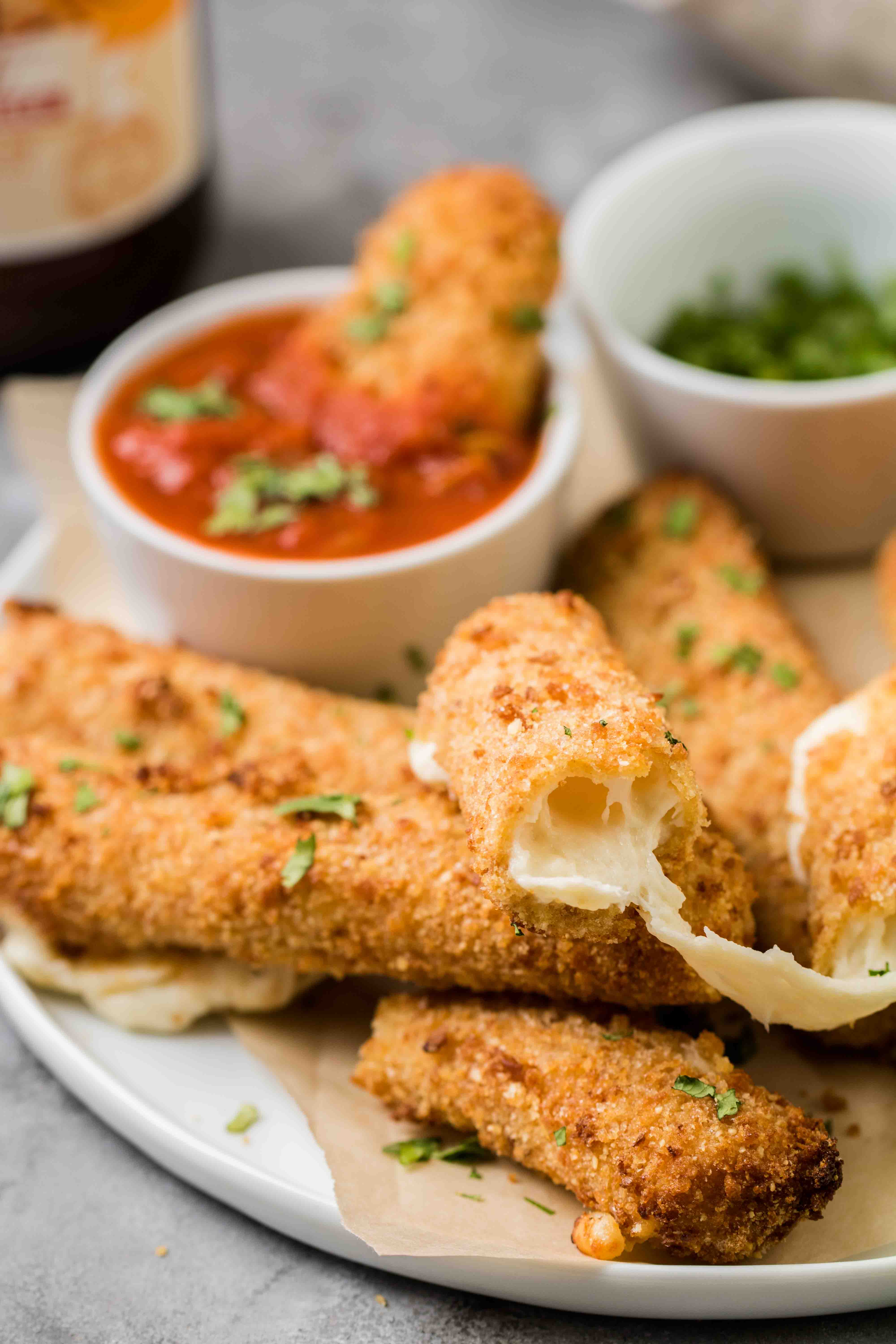 Close up of air fried mozzarella stick oozing with cheese