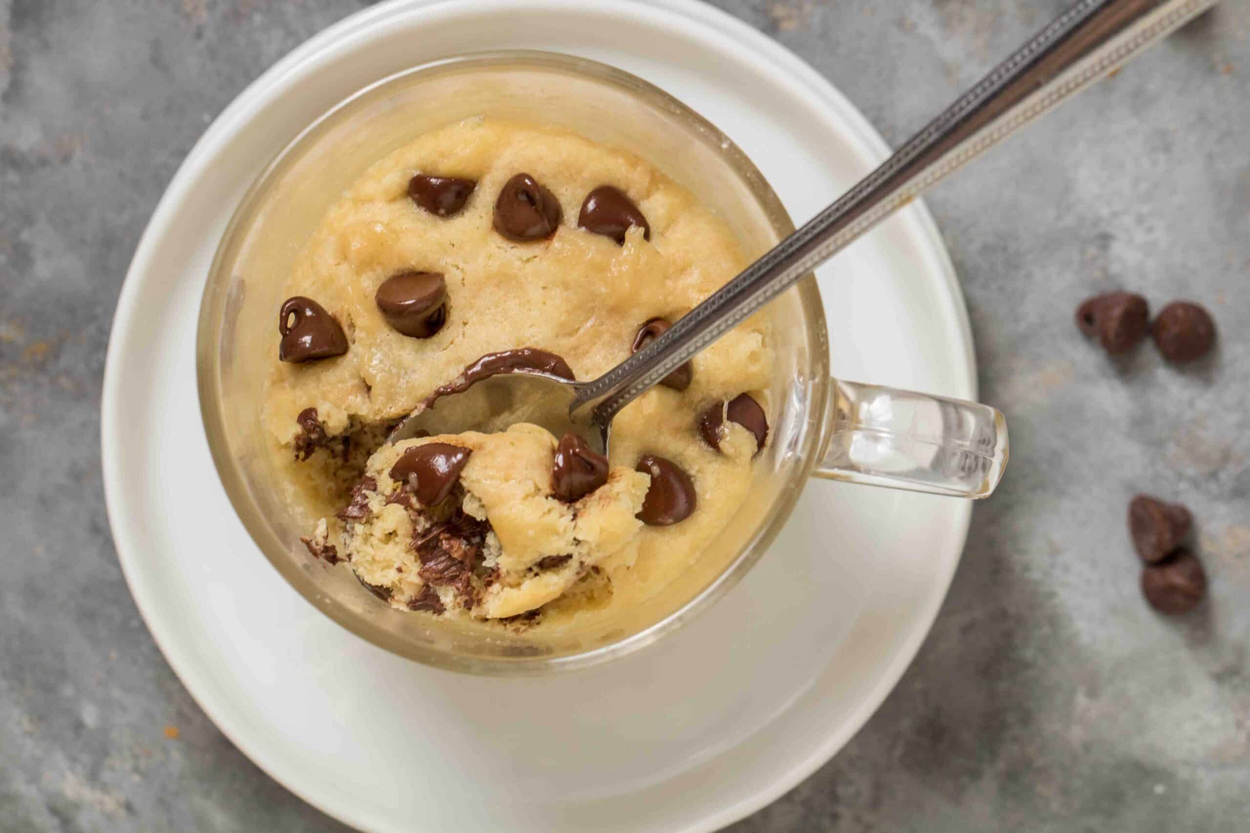 overhead shot of mug cookie with a spoon in it