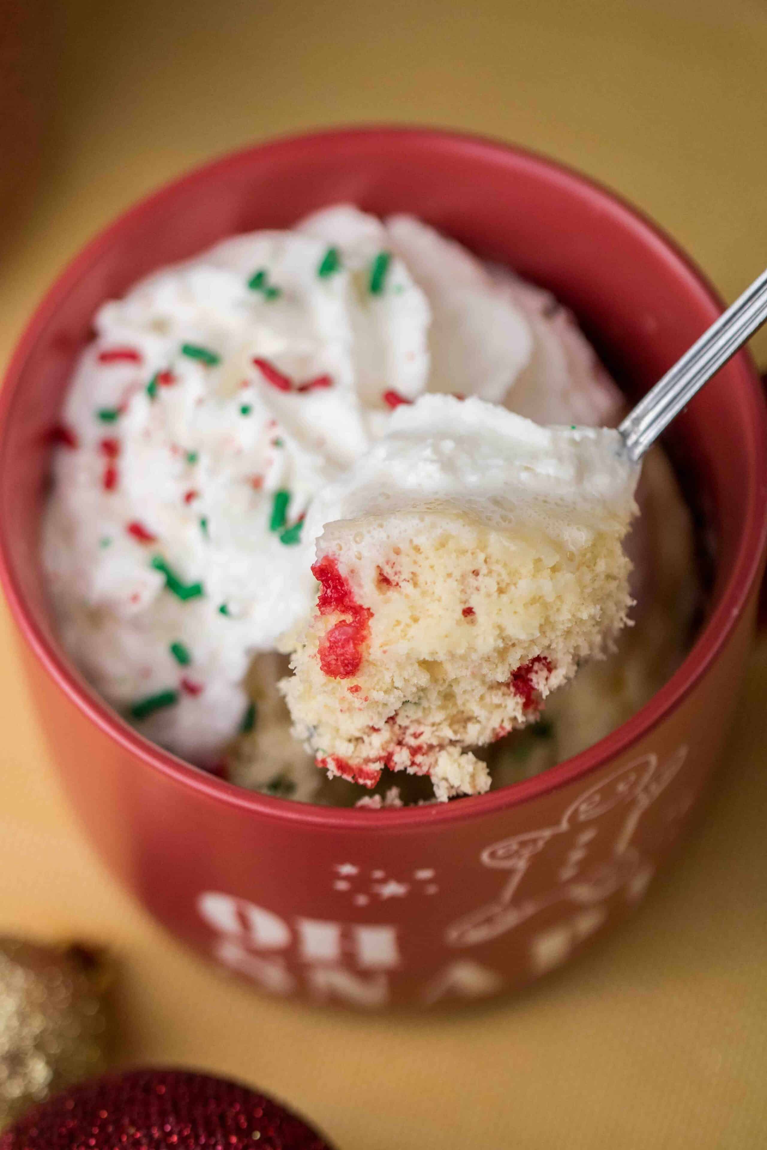 Inside of cake mix mug ccake with Christmas sprinkles