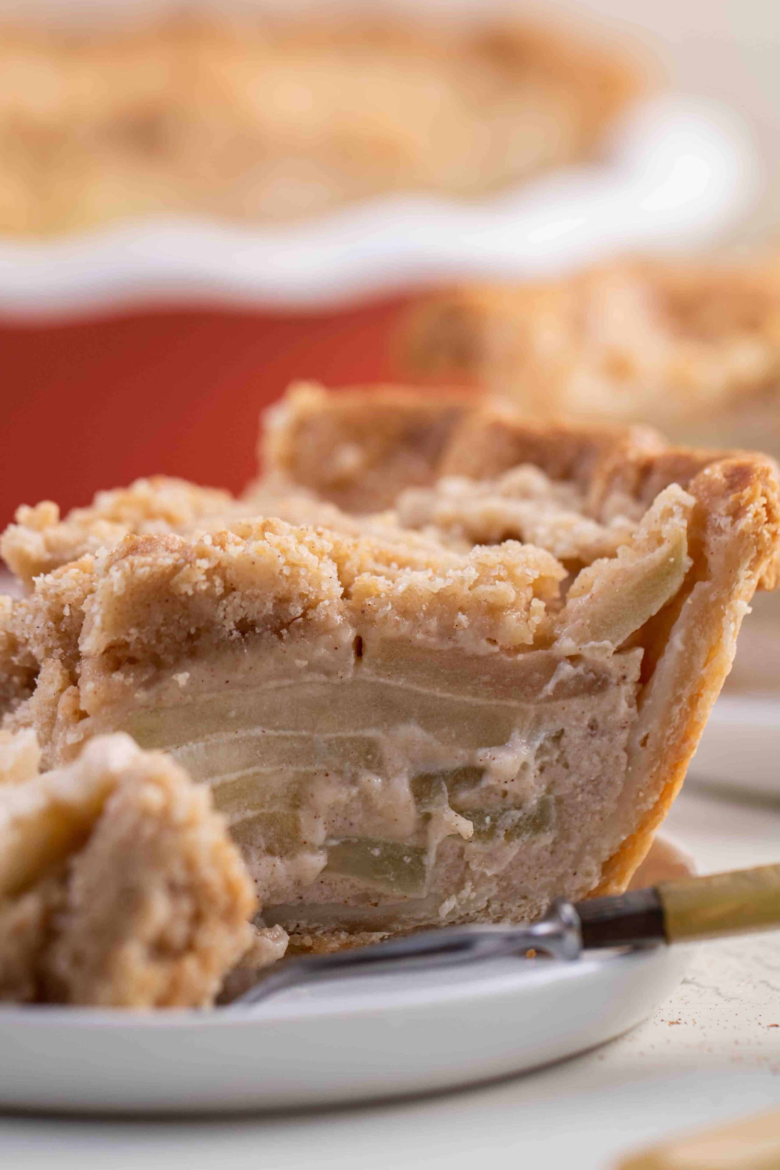 Dutch apple pie with thin apples cooked in between buttery crust and a crumbly topping