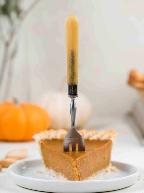 Pumpkin pie slice with a fork in it