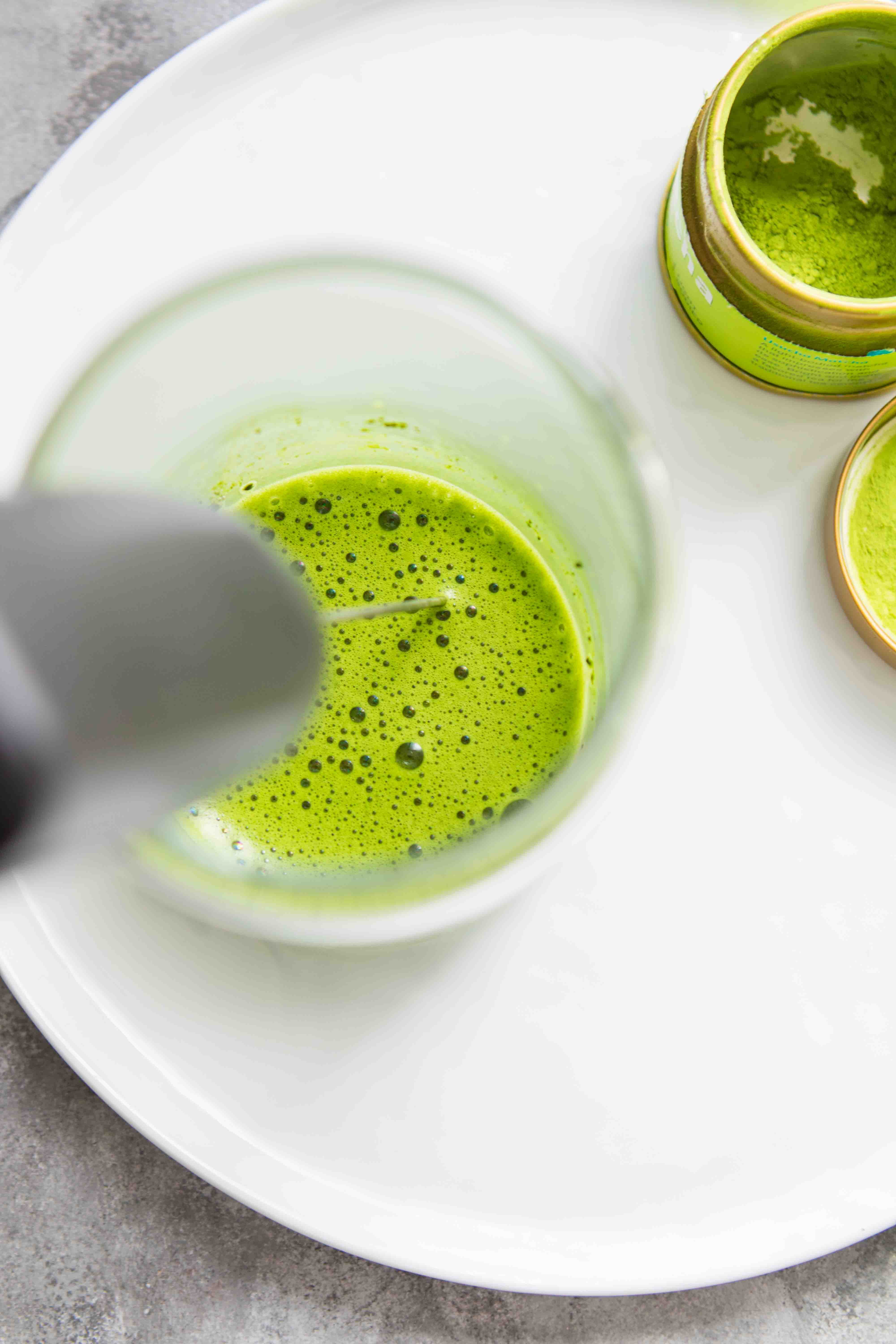 Overhead shot of matcha being mixed for a matcha latte