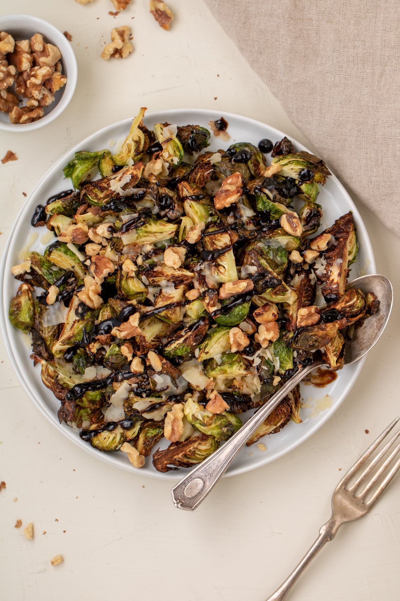 Over head shot of brussel sprouts in a plate with a spoon next to them
