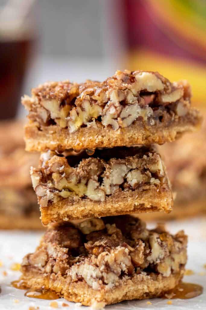 Stack of healthy pecan pie bars with maple drizzle