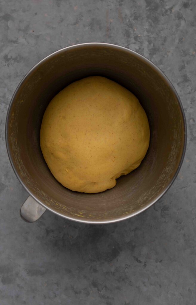 Pumpkin cinnamon roll dough after proofing, risen to double its original size.