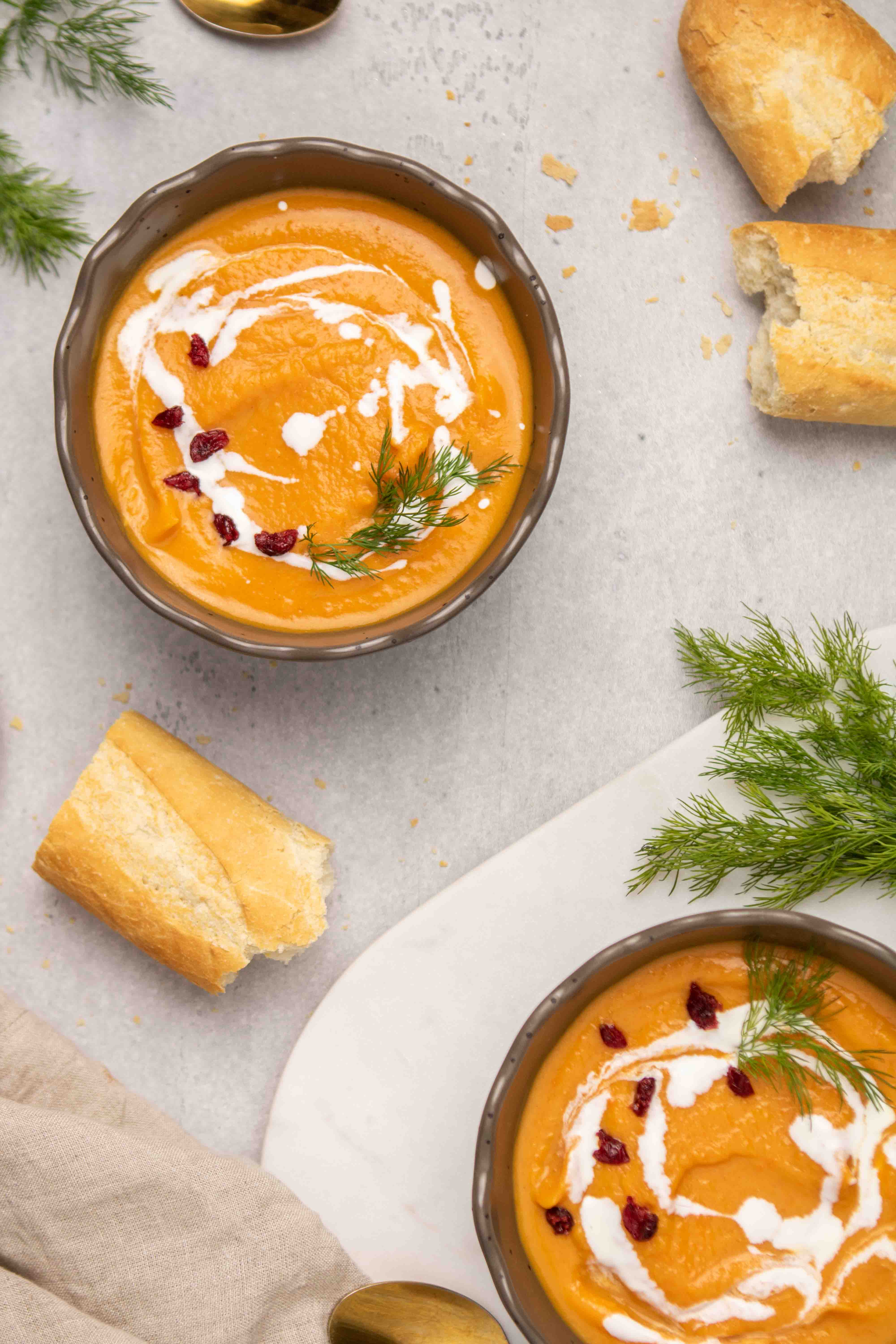 Orange spiced soup with pieces of baguette bread