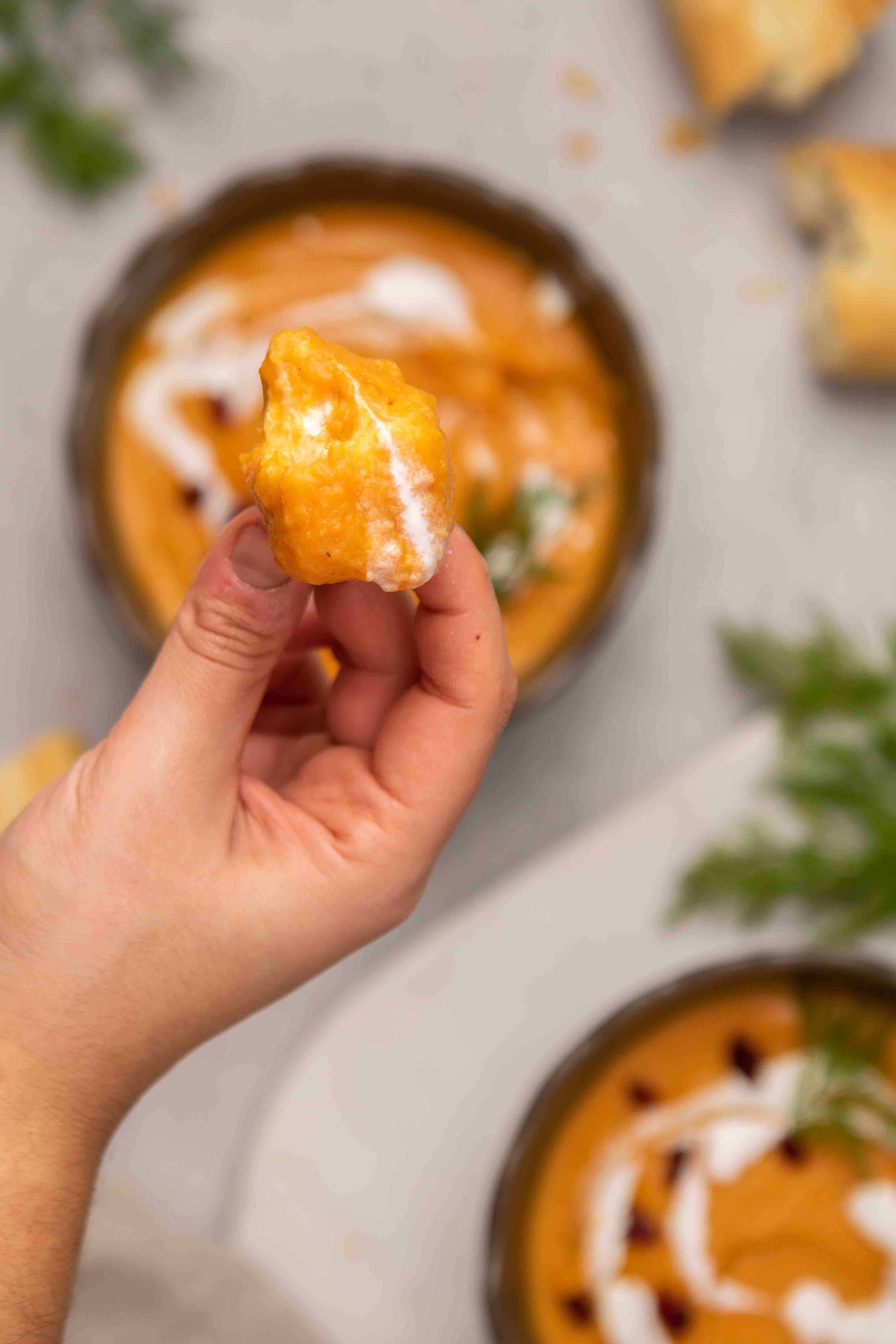 Bread dipped in carrot soup