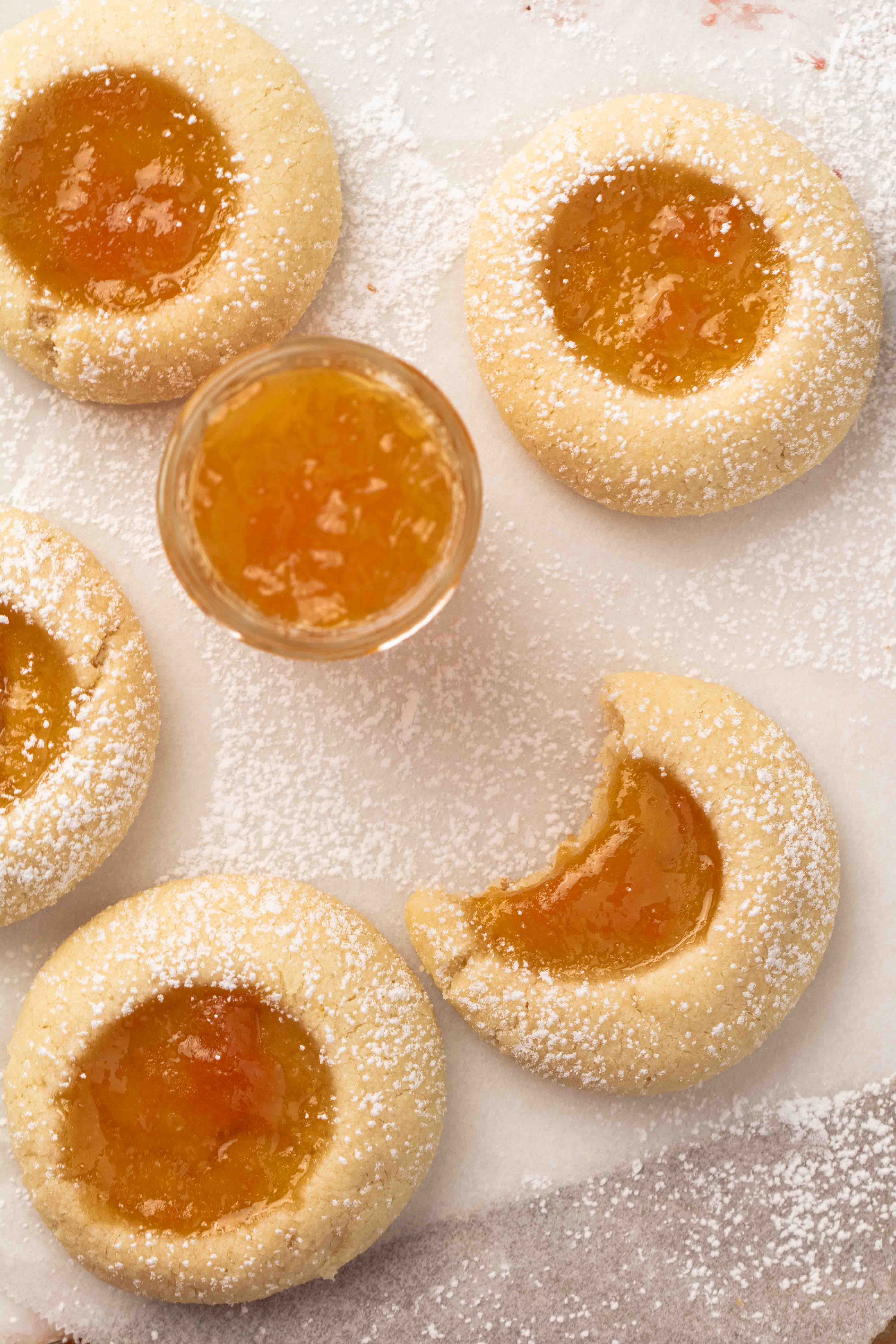 Overhead shot of apricot jam with jam filled cookies