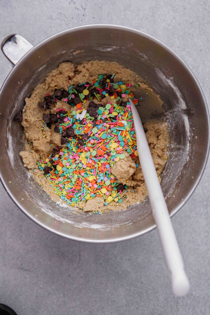 Add the chocolate chips and sprinkles to the cookie dough