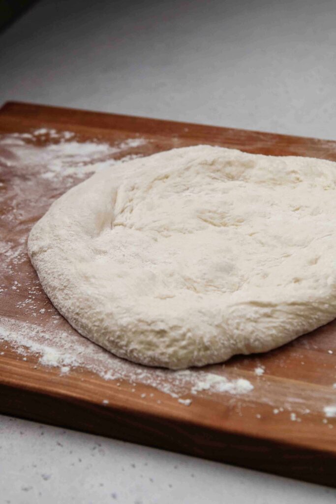 flatten the pizza dough on a well floured surface