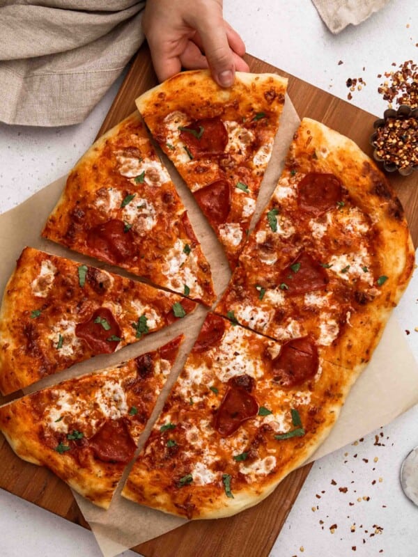 Hand grabbing pizza slice photography