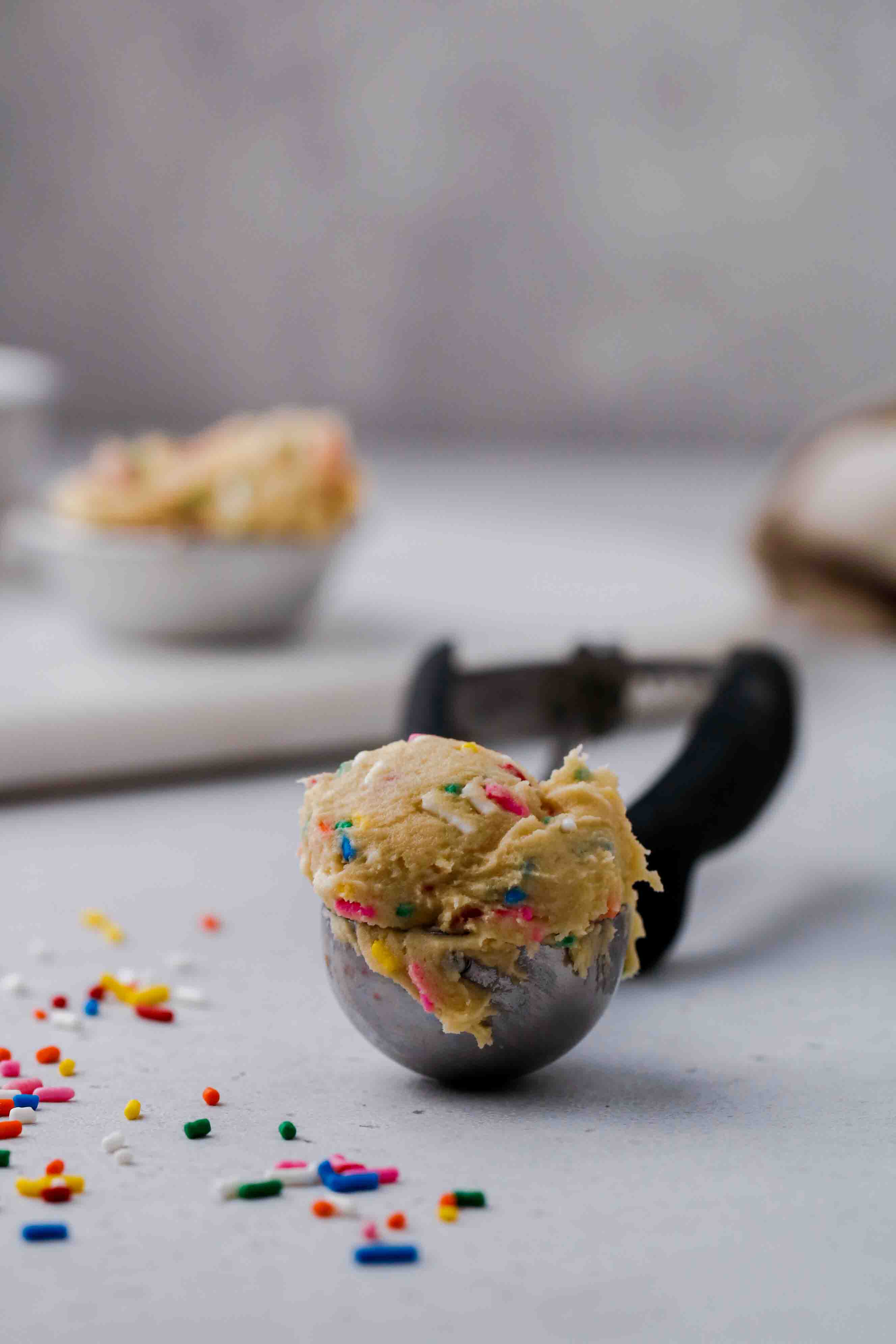 Ice cream scoop full of edible funfetti cookie dough for one
