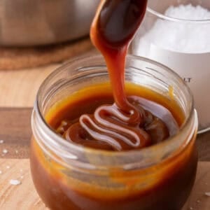 Caramel sauce being poured into a jar