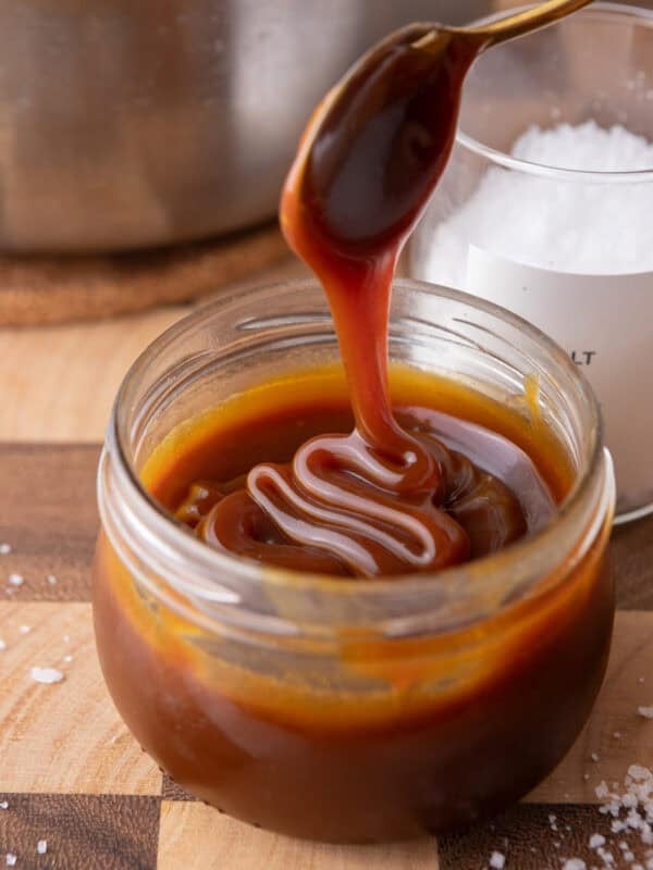 Caramel sauce being poured into a jar