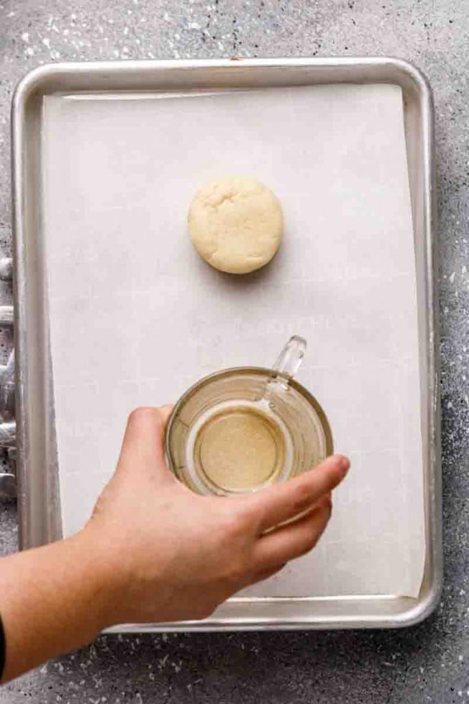 Press down the cookie dough with the back of a cup