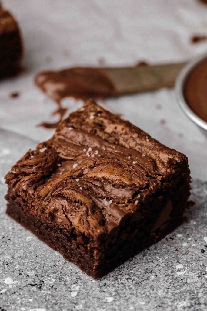 Small batch Nutella brownie square with swirled Nutella on top and a fudgy chocolate interior sprinkled with flaky sea salt