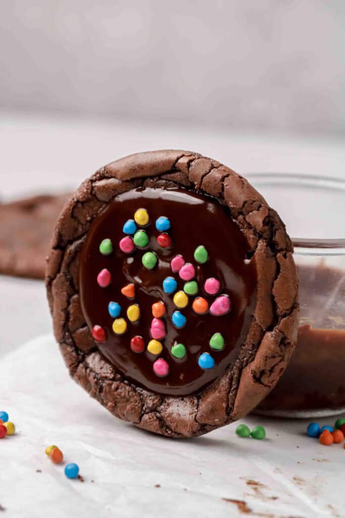 Cosmic brownie cookie leaned against glass