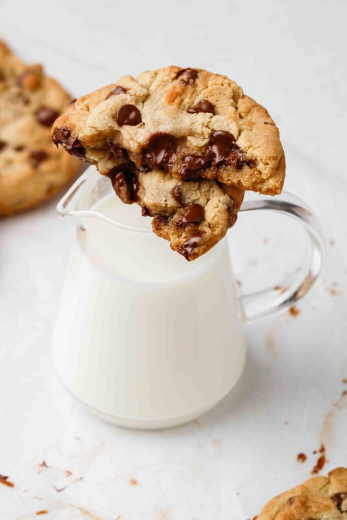 Chewy milk chocolate chip cookie on a milk pitcher