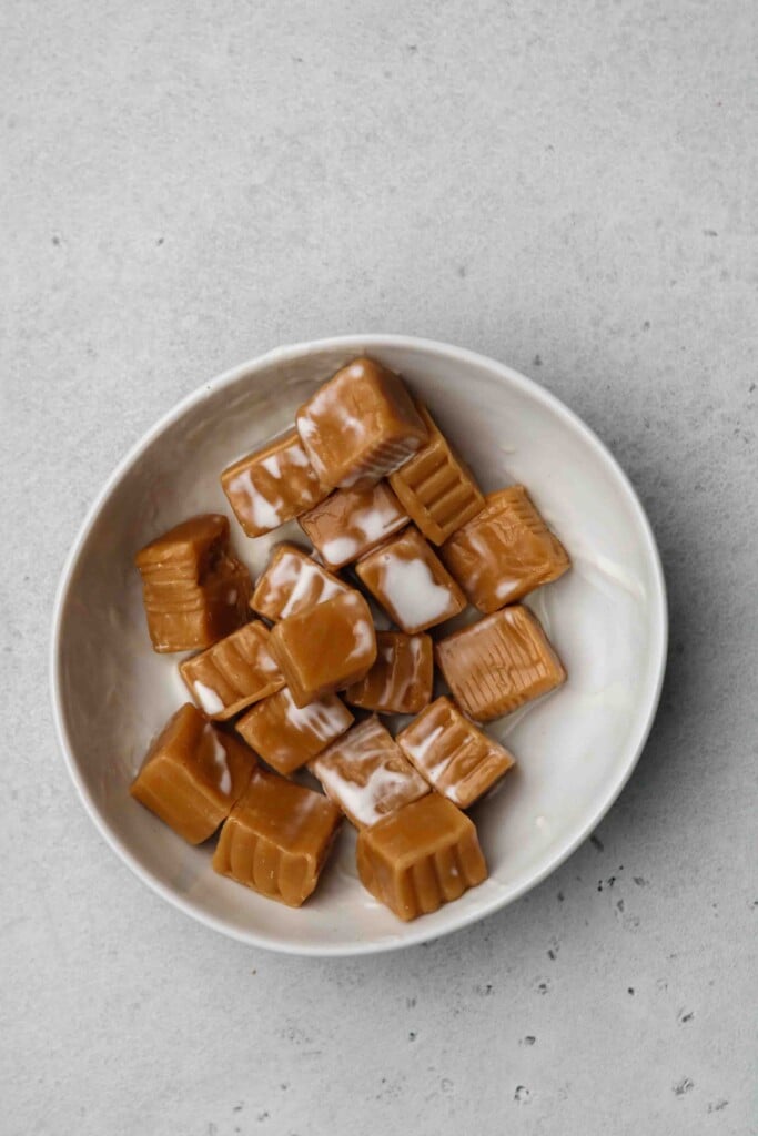 Caramels and heavy cream in a bowl