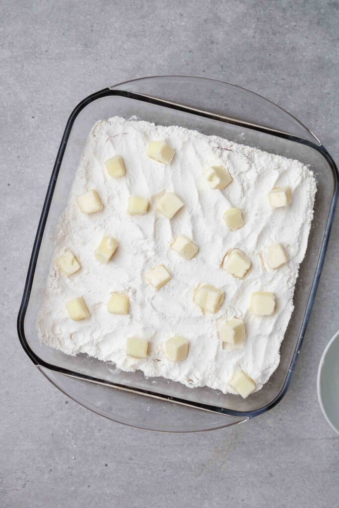 Butter cubes on top of cake mix layer