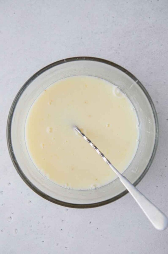 Mixing lemon juice with sweetened condensed milk