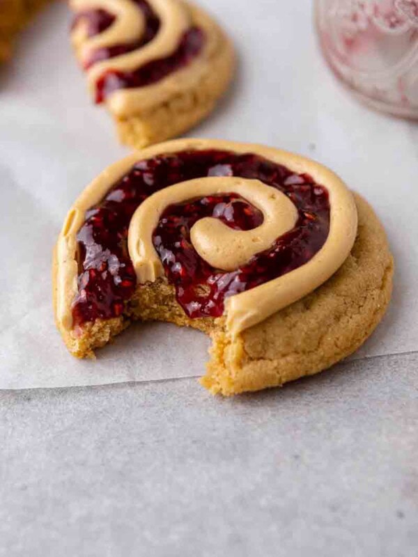 Peanut butter and jelly cookies with a bite taken out of it