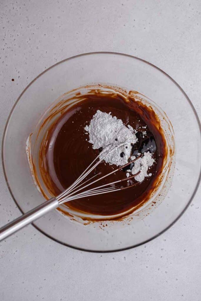 Adding sugar and vanilla to chocolate ganache