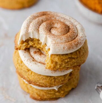 Stacked frosted pumpkin cookies