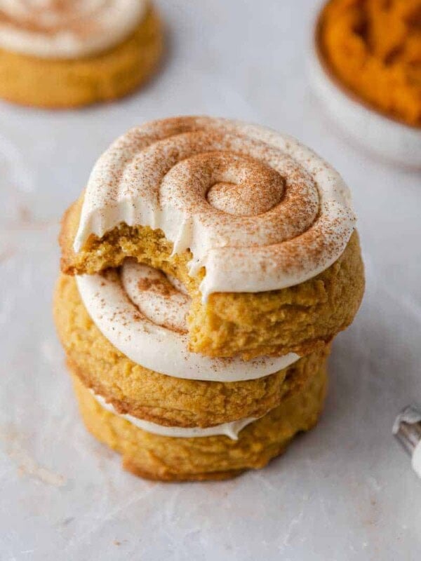 Stacked frosted pumpkin cookies