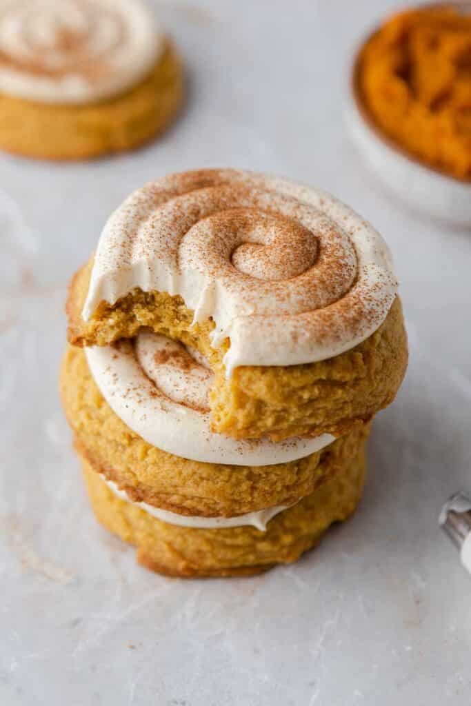 Stacked frosted pumpkin cookies