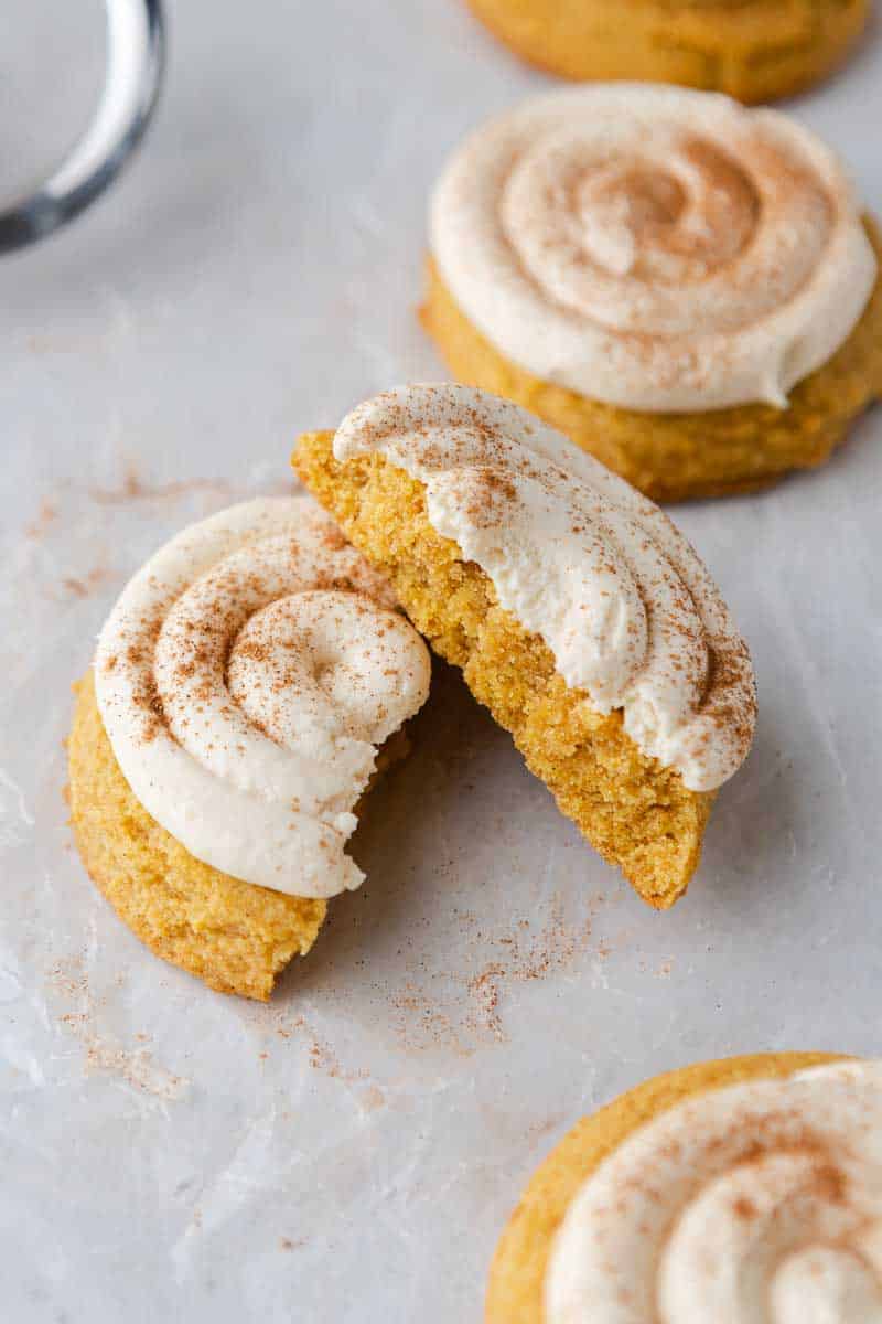 Frosted Crumbl caramel pumpkin cookies dusted with pumpkin pie spice.