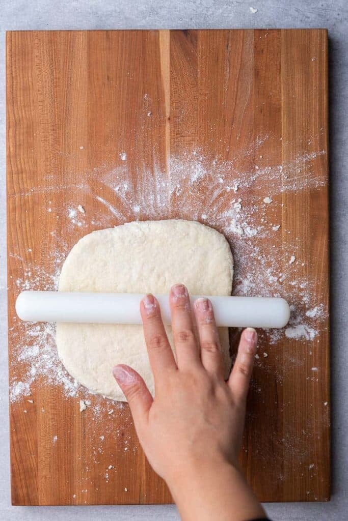 Hand rolling biscuit dough