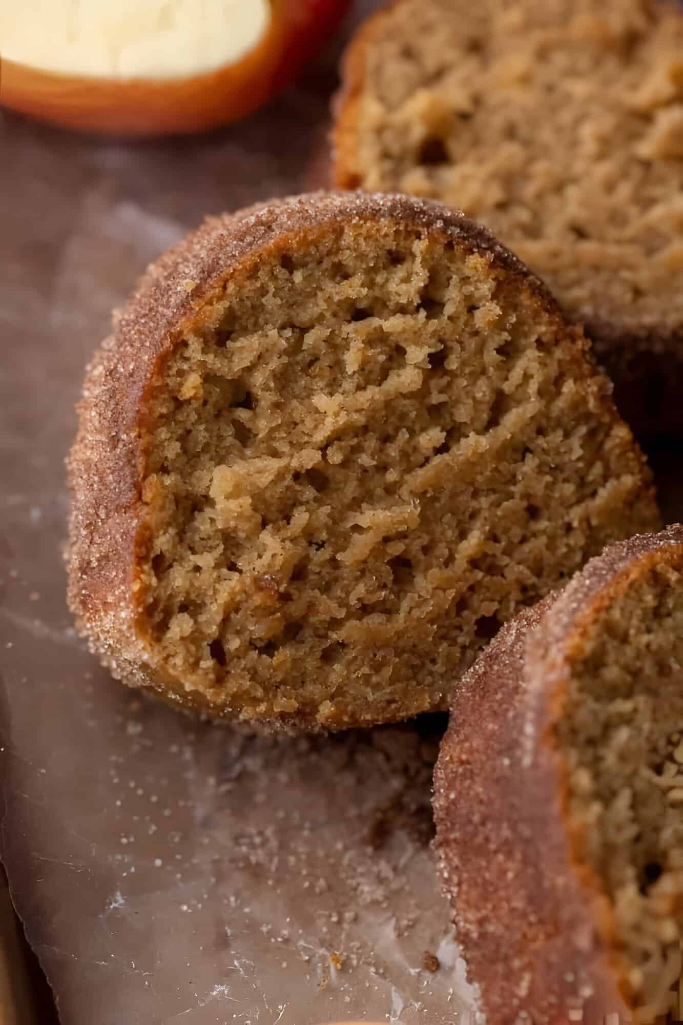 Slice of apple cider donut bundt cake with a tender crumb and thick cinnamon sugar crust.