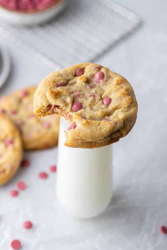 Thick ruby chocolate chip cookie on milk glass