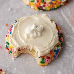 Crumbl funfetti milkshake cookie with a bite taken out of it